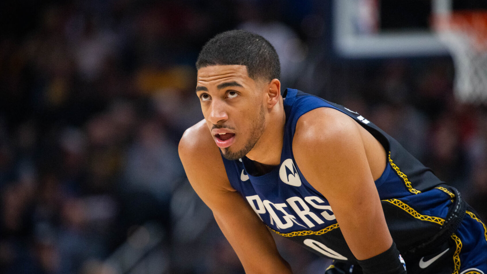 Indiana Pacers guard Tyrese Haliburton resting his hands on his knees during a game