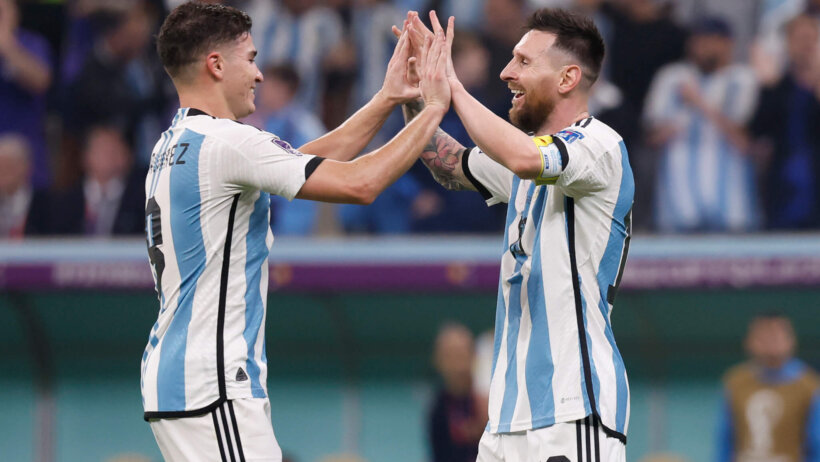 Argentina forward Julian Alvarez celebrates with forward Lionel Messi after scoring a goal