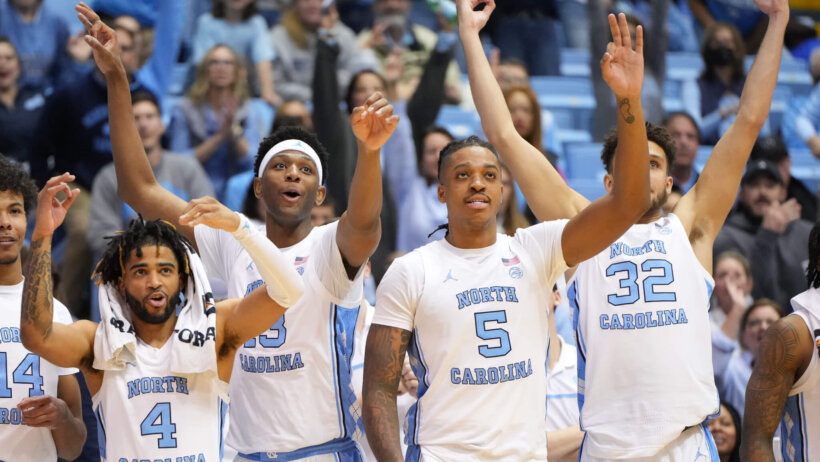 UNC players celebrating a three.