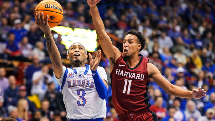 Kansas Jayhawks guard Dajuan Harris Jr. shooting against Harvard guard in the second half of the game.