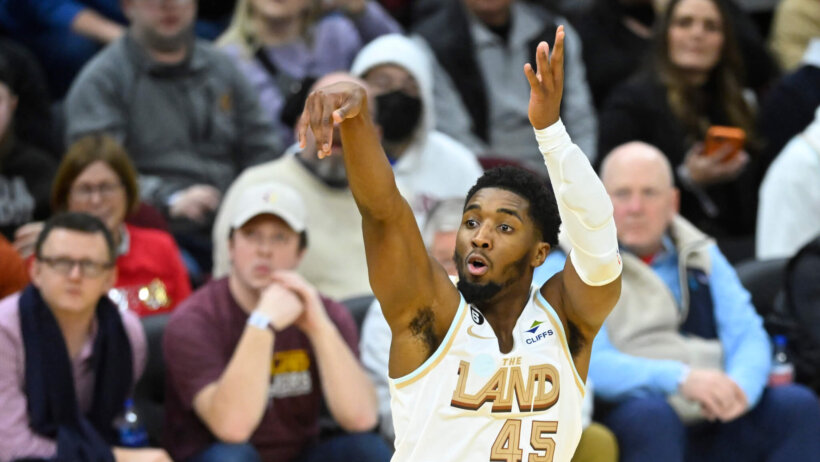 Cleveland Cavaliers Donovan Mitchell follow through on shot basketball white jersey