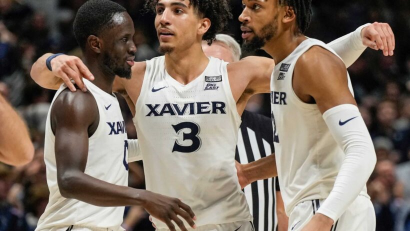 Xavier Musketeers players huddling during a game.