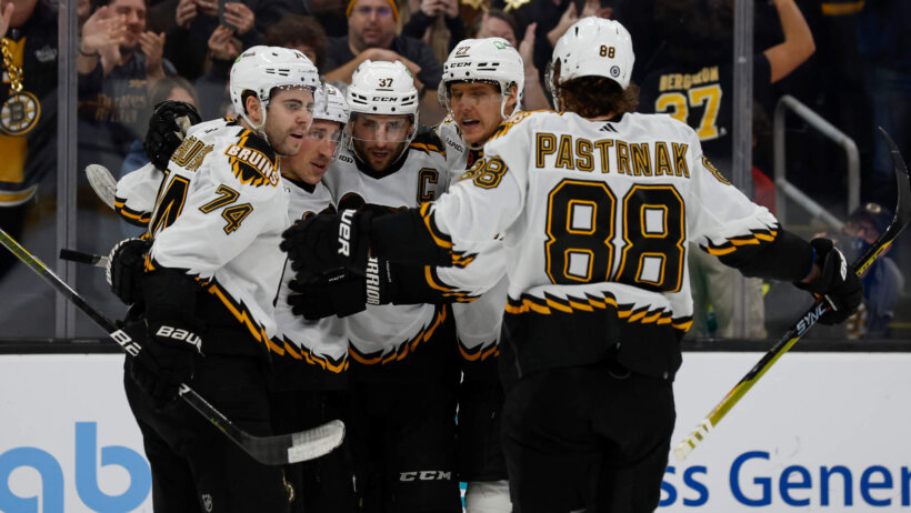 Boston Bruins center Patrice Bergeron is congratulated by teammates