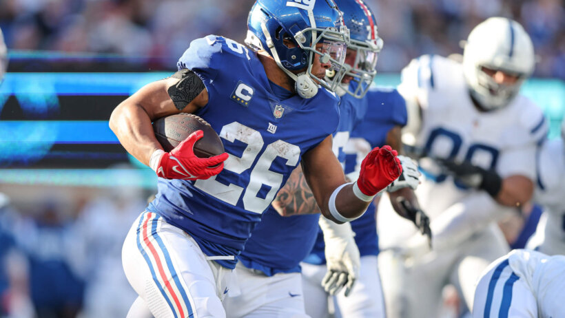 Saquon Barkley running with the football