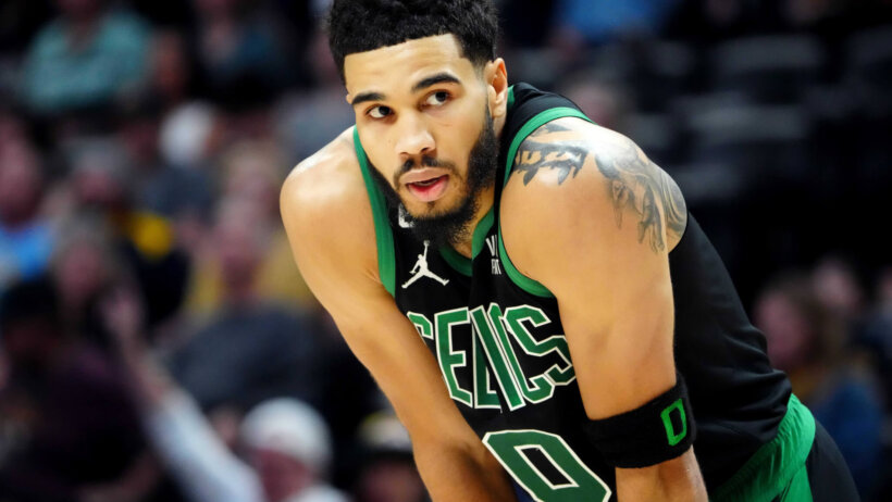 Boston Celtics forward Jayson Tatum resting his hands on his knees