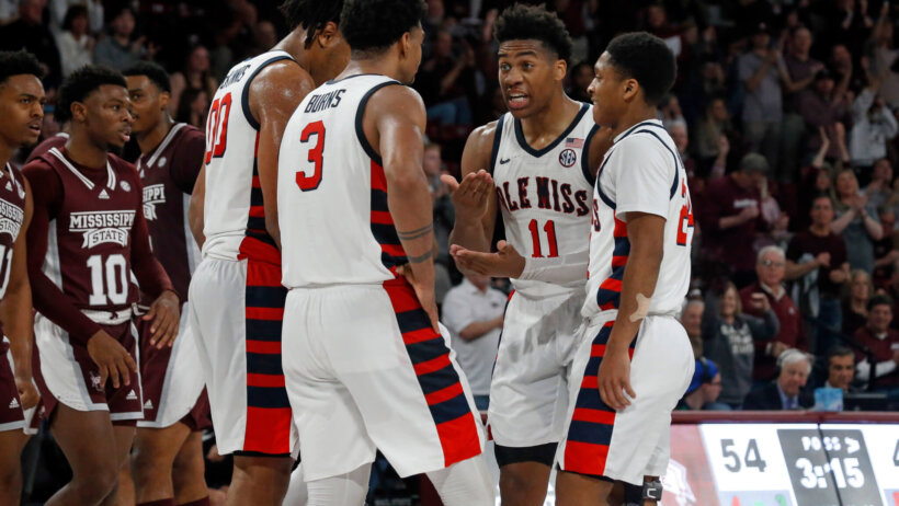 Mississippi Rebels basketball players huddling on the court