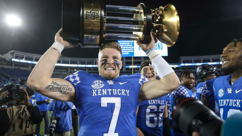 Kentucky's Will Levis grimaces while hoisting the 2022 Governor's Cup trophy