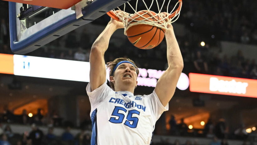 Creighton Bluejays guard Baylor Scheierman dunking the ball during a game.