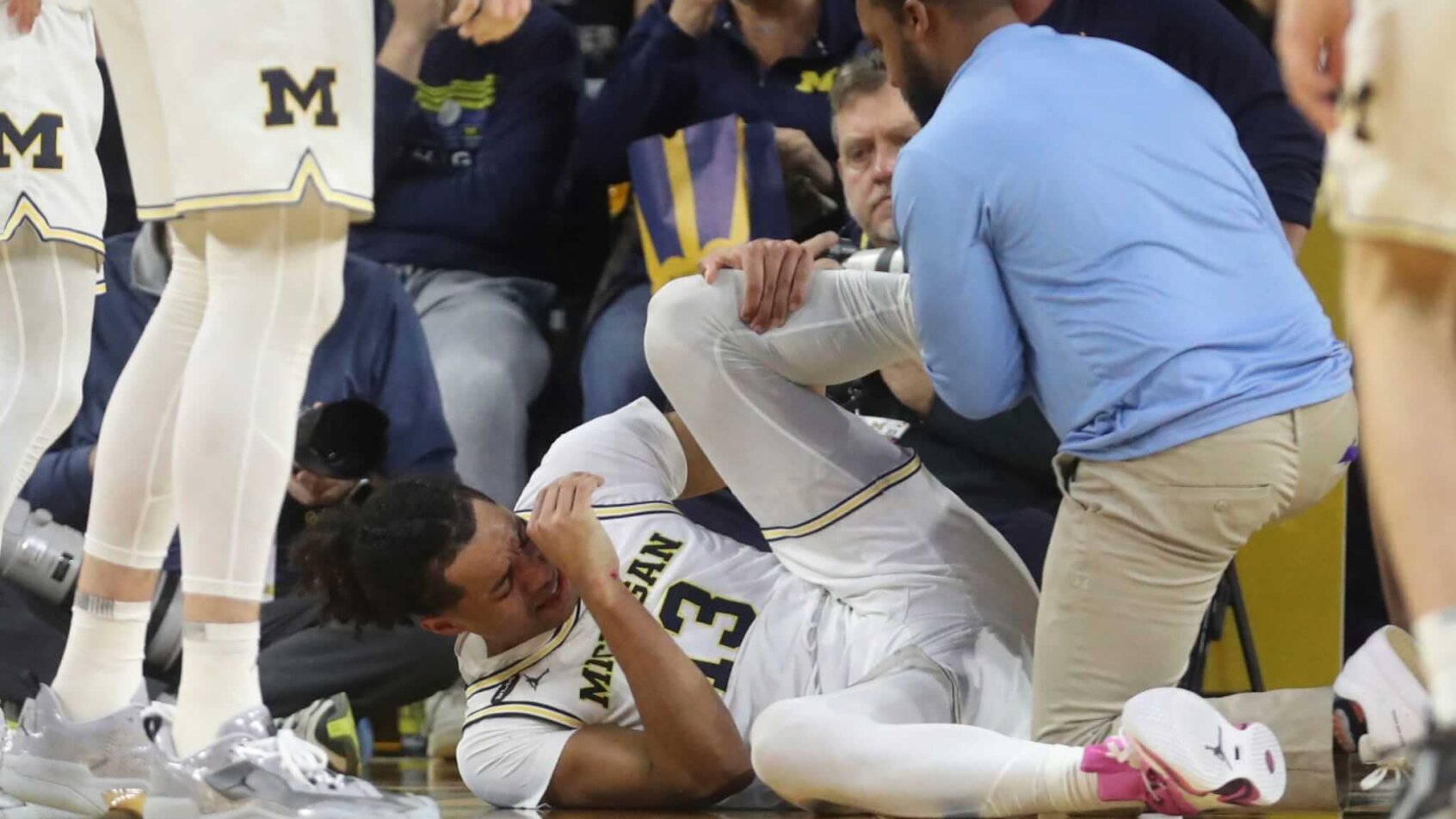 Michigan guard Jett Howard lays on the floor injured