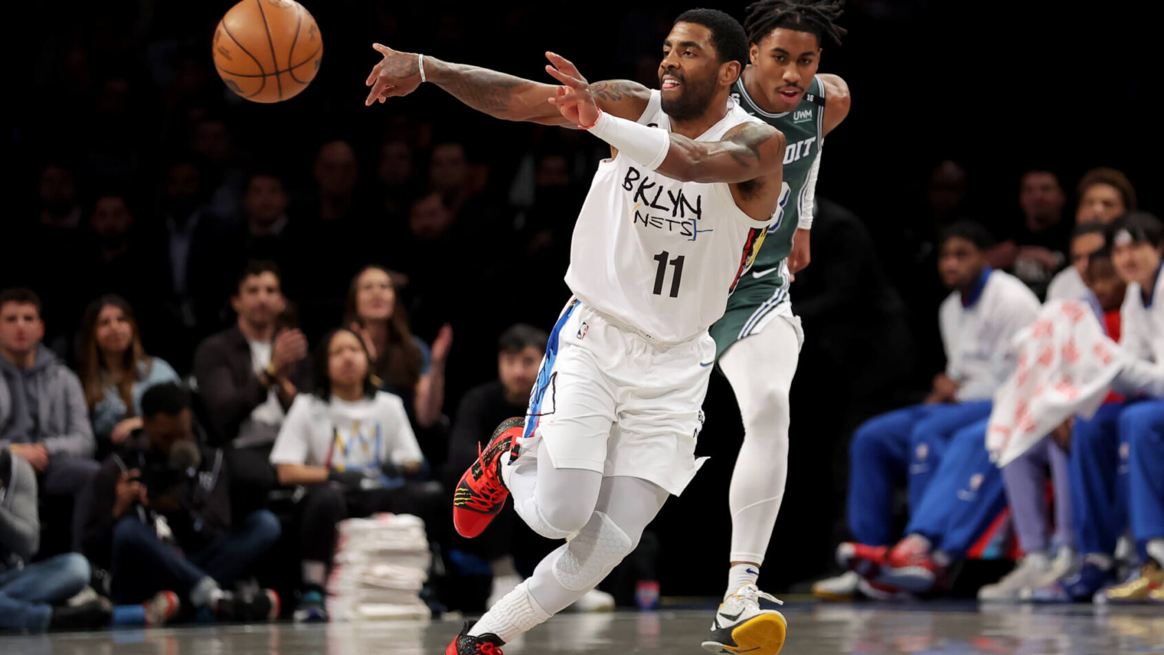 Kyrie Irving passing the ball during a game.