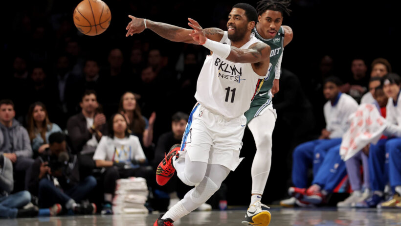 Kyrie Irving passing the ball during a game.