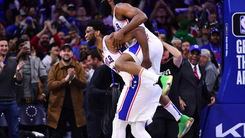 Philadelphia 76ers guard James Harden celebrates with center Joel Embiid