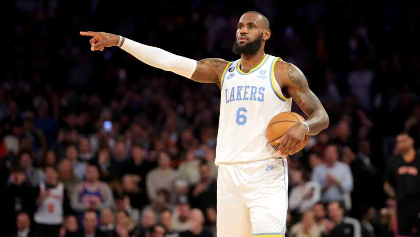 LeBron James holds the ball and points