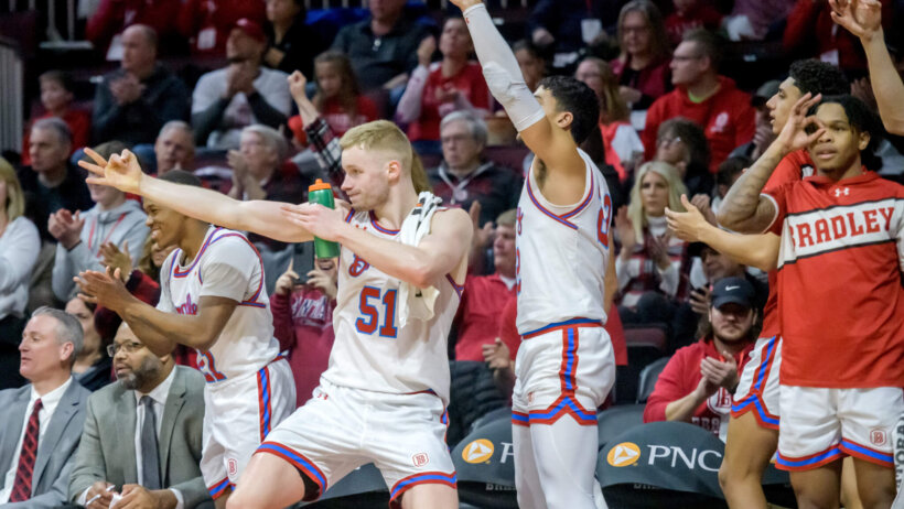 Bradley players celebrating on the bench
