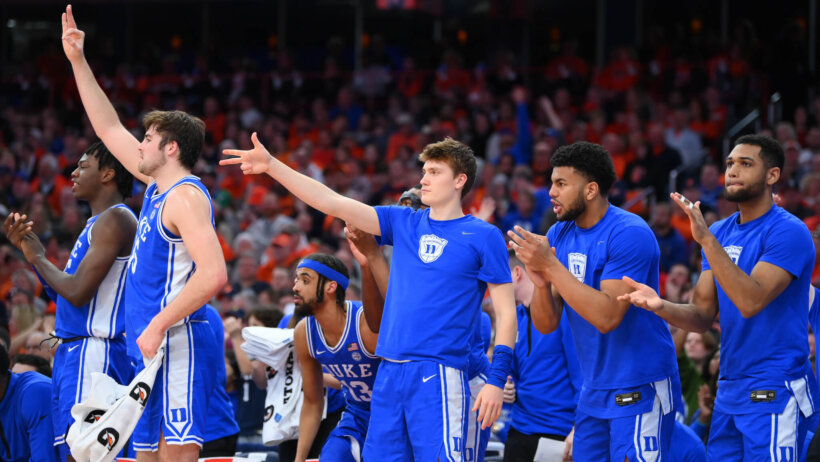 Duke Blue Devils players reacting on the bench