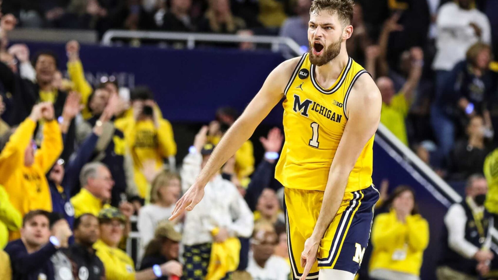 Michigan center Hunter Dickinson celebrates making a three