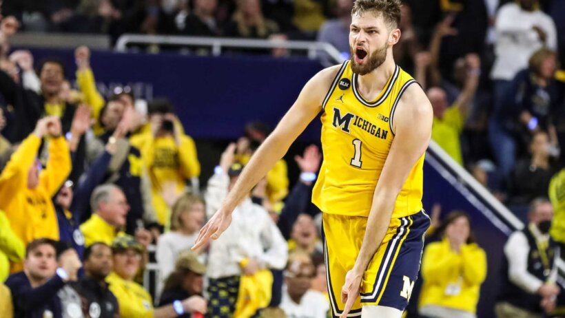 Michigan center Hunter Dickinson celebrates making a three
