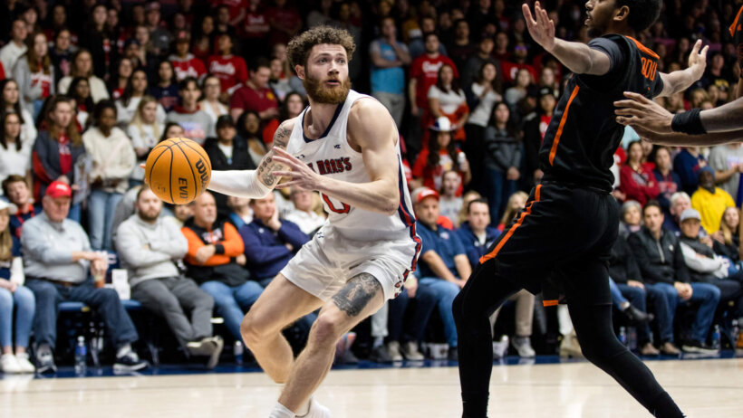 Logan Johnson drives against defender