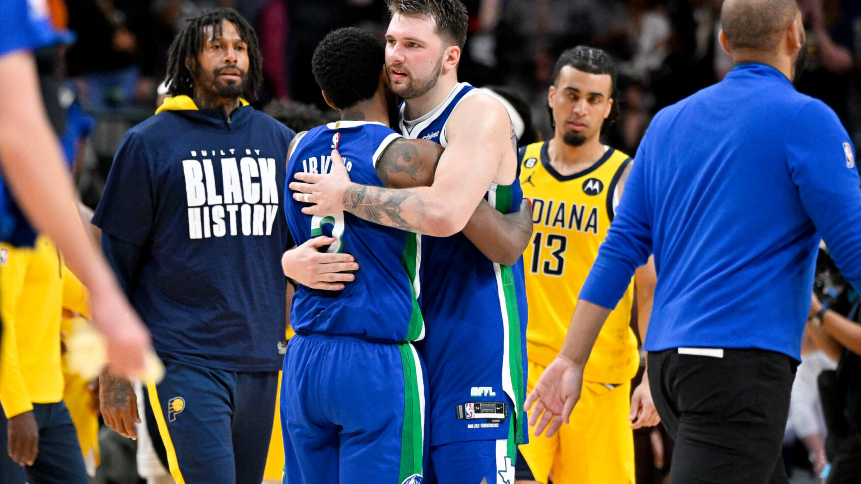 Dallas Mavericks guard Luka Doncic (77) hugs guard Kyrie Irving (2)