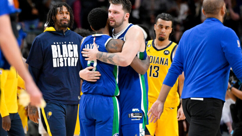 Dallas Mavericks guard Luka Doncic (77) hugs guard Kyrie Irving (2)