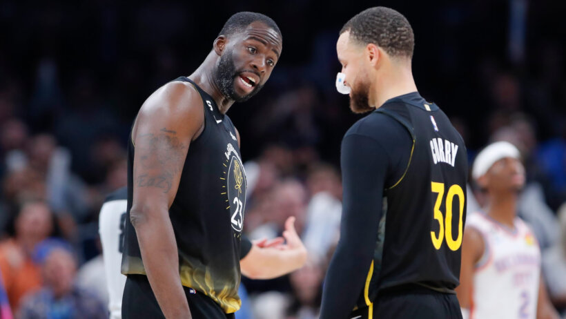 Golden State Warriors forward Draymond Green talks with guard Stephen Curry
