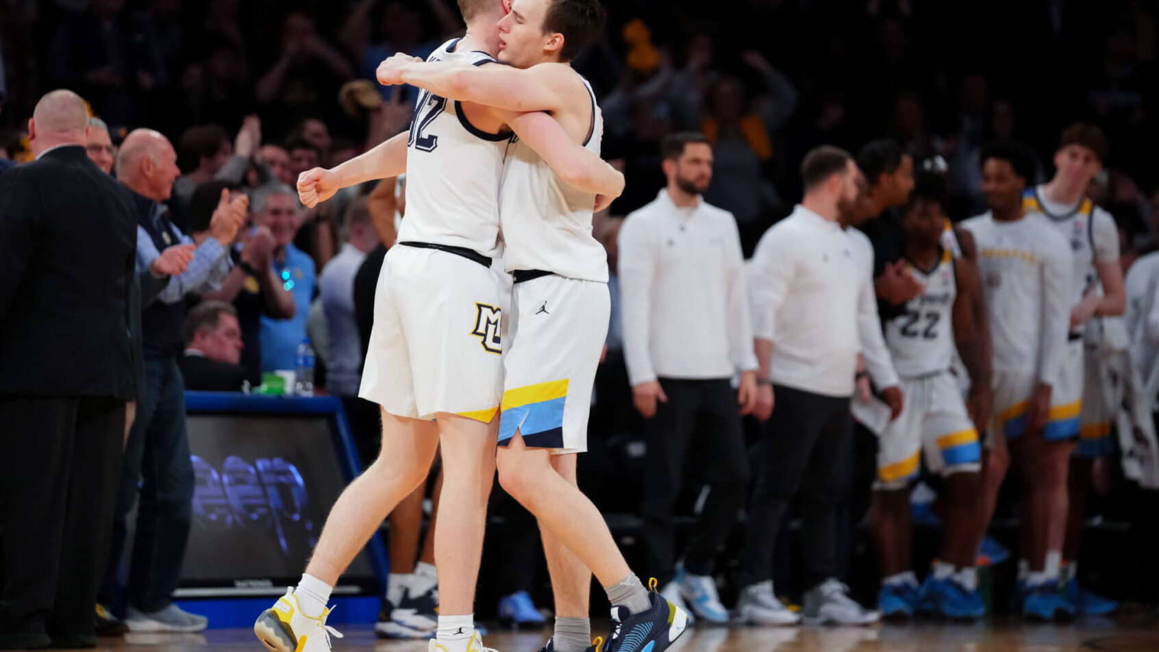 Marquette Golden Eagles guard Tyler Kole hugs forward Michael Kennedy