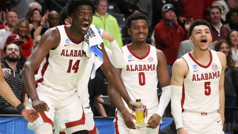Alabama players react in celebration on the bench