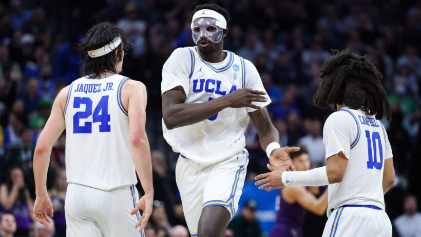 UCLA Bruins forward Adem Bona high fives teammates
