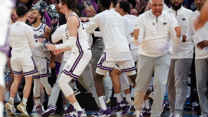 Kansas State Wildcats players celebrating on the sideline