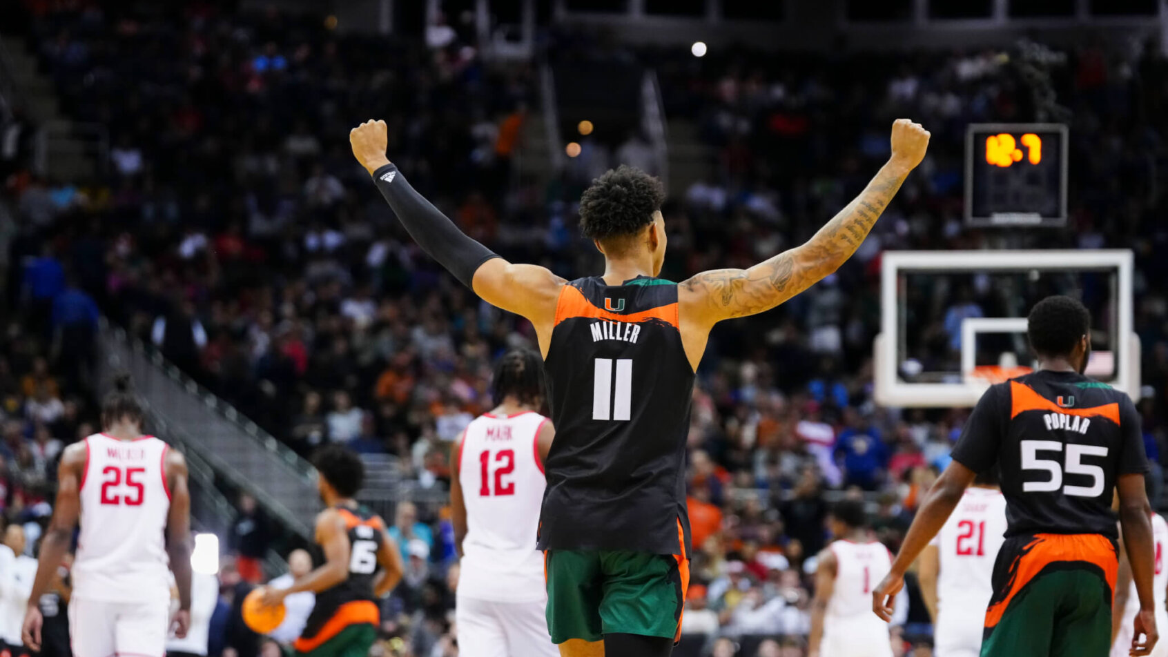 Miami Hurricanes guard Jordan Miller raises his arms
