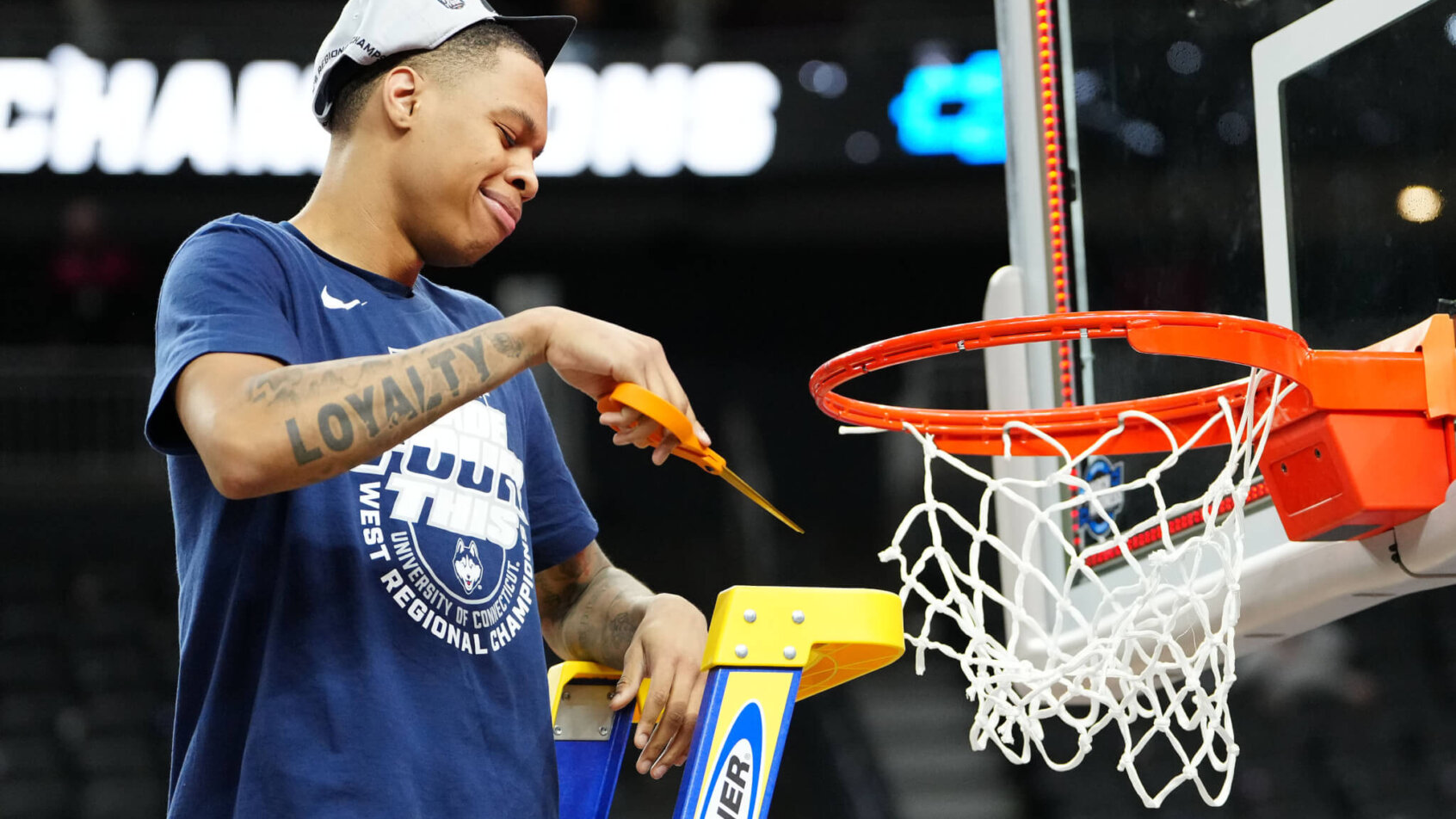 Connecticut Huskies guard Jordan Hawkins cuts down the nets