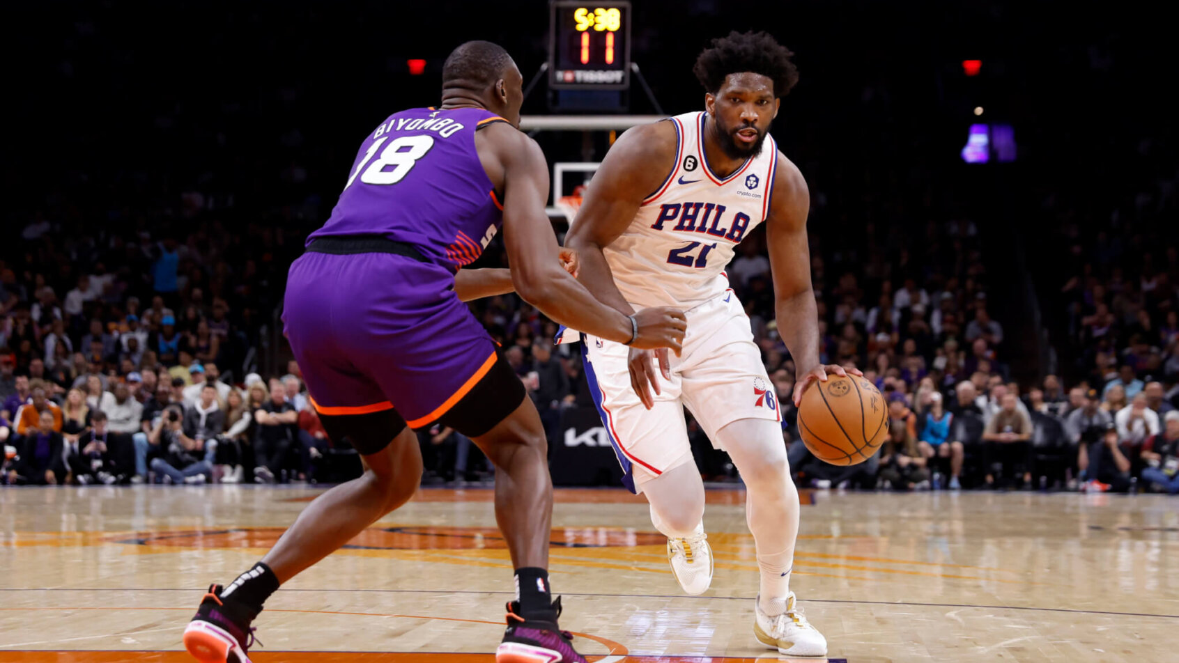 Joel Embiid dribbles at a defender