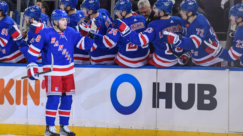 Patrick Kane celebrating with teammates at bench