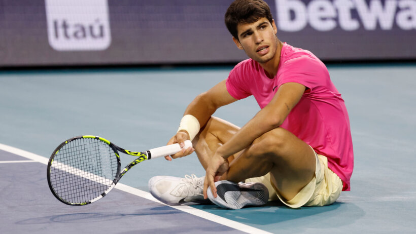 Carlos Alcaraz reacts after losing a point