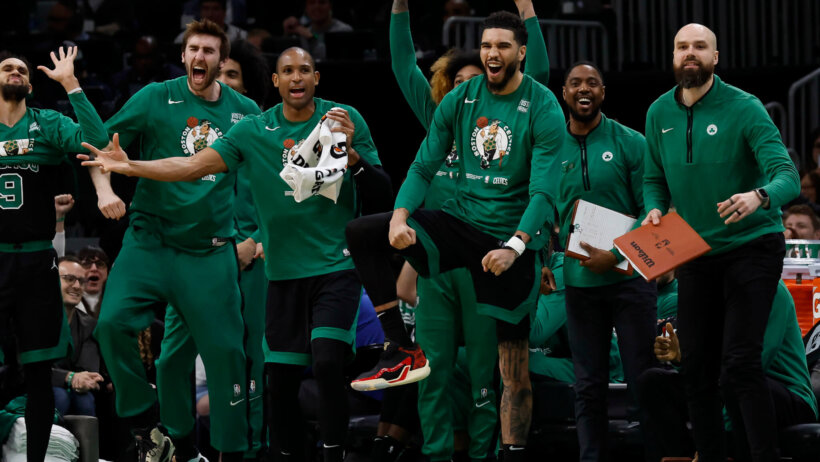 Jayson Tatum and the rest of the Boston Celtics celebrate on the bench.