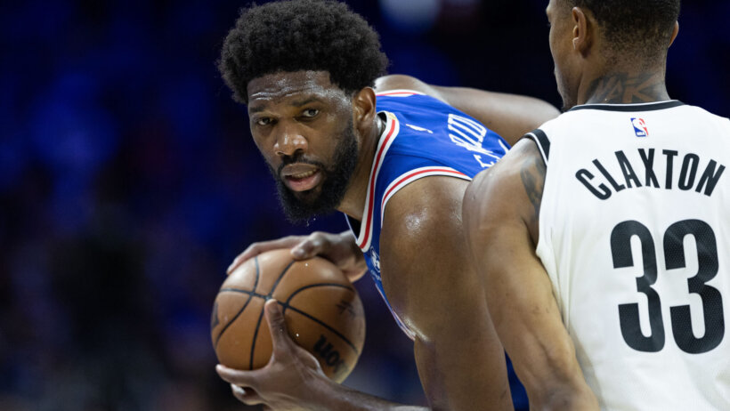 Philadelphia 76ers center Joel Embiid shields the ball from a defender