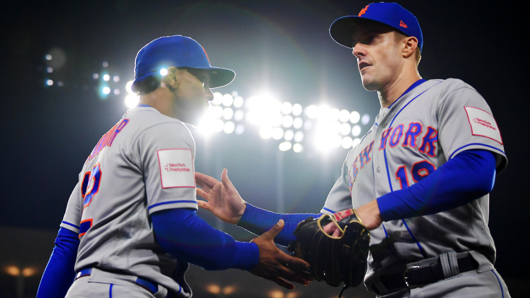 New York Mets shortstop Francisco Lindor greets left fielder Mark Canha