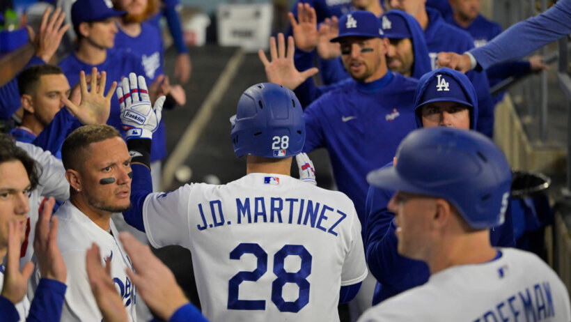 Los Angeles Dodgers left fielder J.D. Martinez celebrates in the dugout