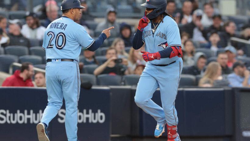 Vladimir Guerrero Jr. celebrates his two run home run with third base coach Luis Rivera