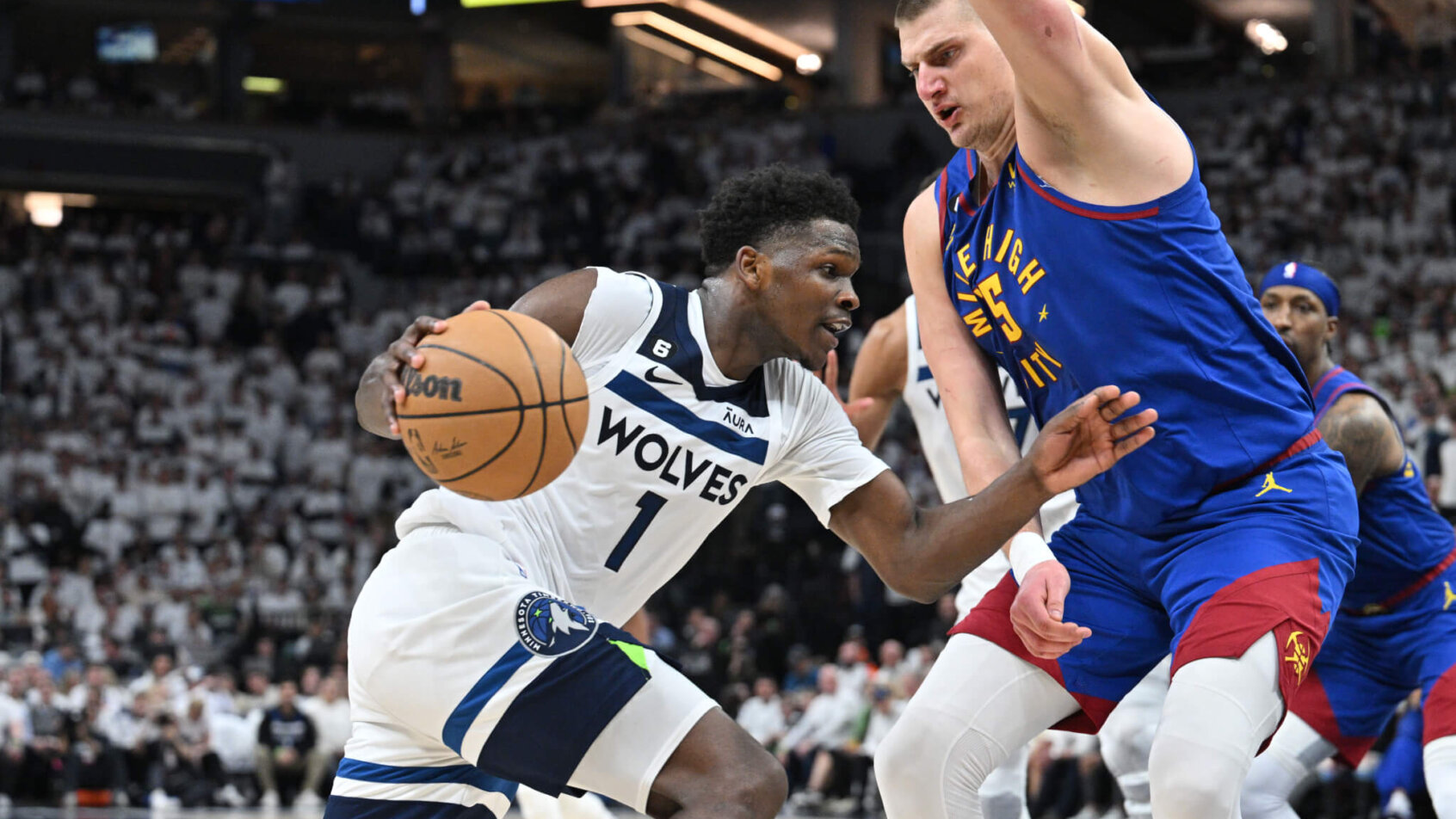 Anthony Edwards drives on Nikola Jokic