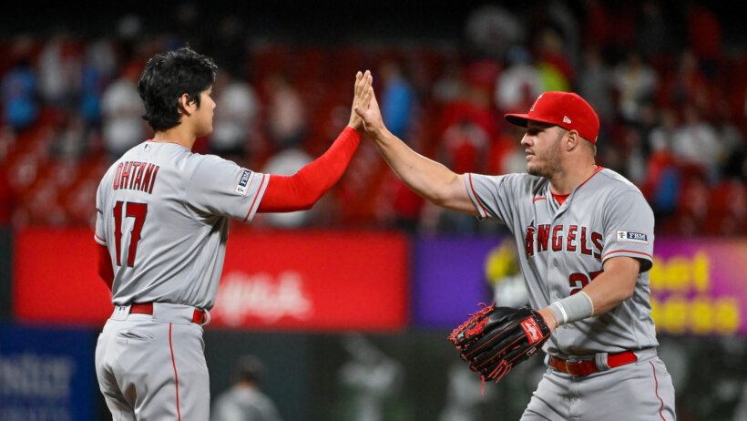 Los Angeles Angels starting pitcher Shohei Ohtani high-fives center fielder Mike Trout