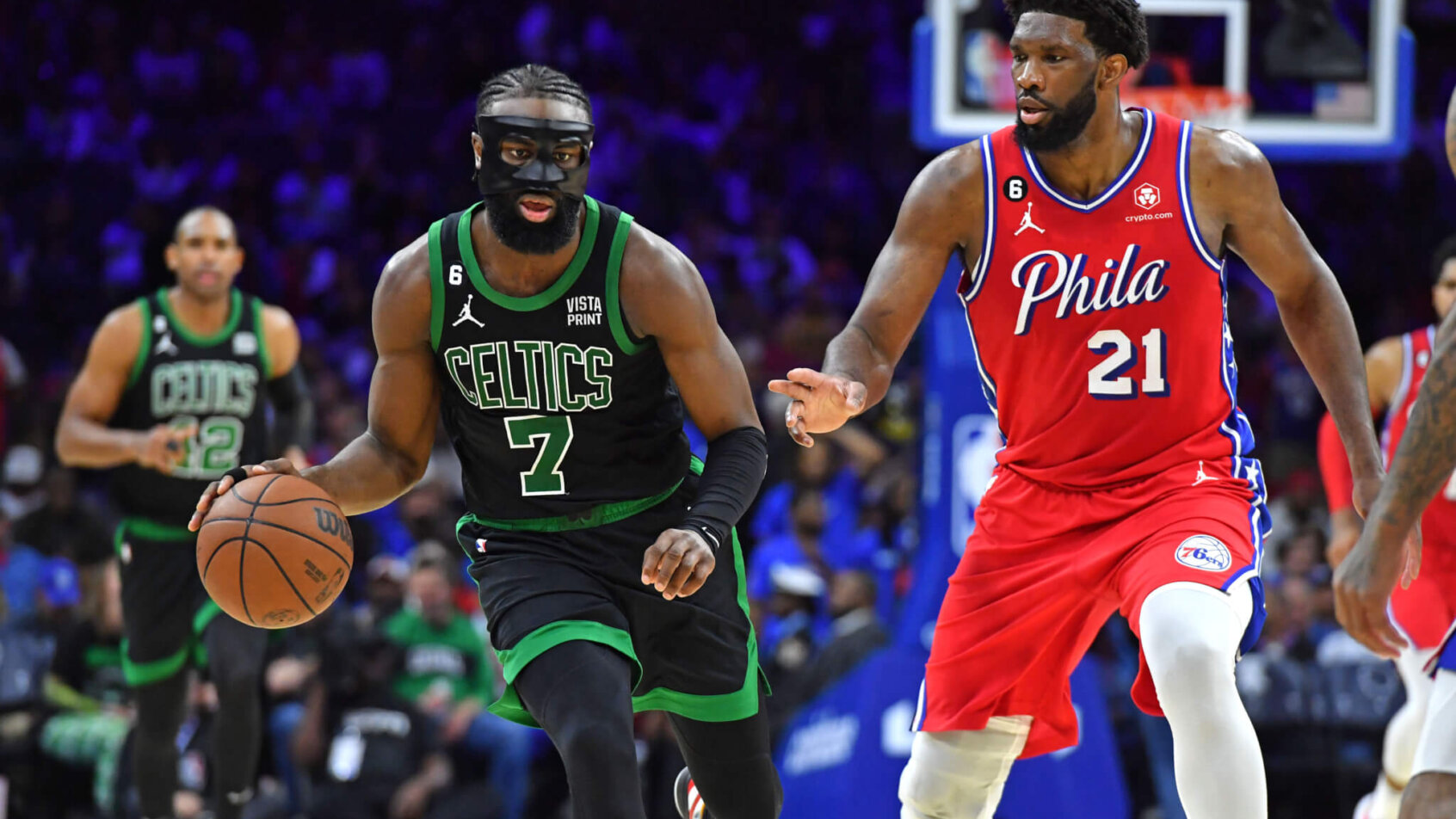 Boston Celtics guard Jaylen Brown is defended by Philadelphia 76ers center Joel Embiid