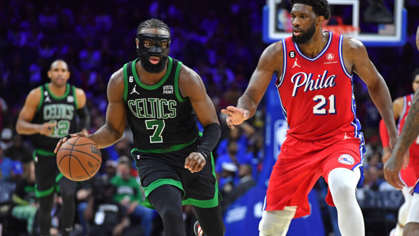 Boston Celtics guard Jaylen Brown is defended by Philadelphia 76ers center Joel Embiid