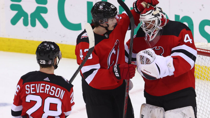 New Jersey Devils defenseman Luke Hughes (43) and New Jersey Devils goaltender Vitek Vanecek (41) celebrate the Devils win.