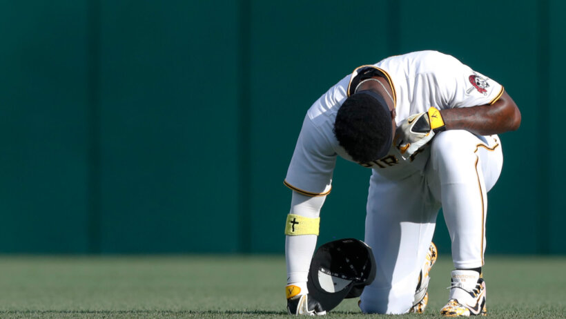 Pittsburgh Pirates designated hitter Andrew McCutchen taking a knee