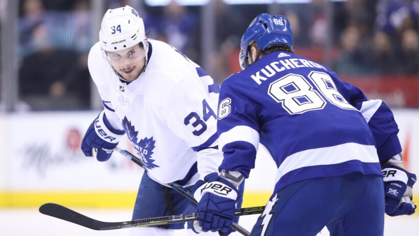 Toronto Maple Leafs center Auston Matthews talks to Tampa Bay Lightning right wing Nikita Kucherov