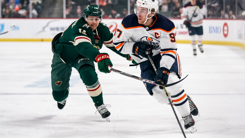 Edmonton Oilers forward Connor McDavid skates with the puck against Minnesota Wild forward Joel Eriksson Ek