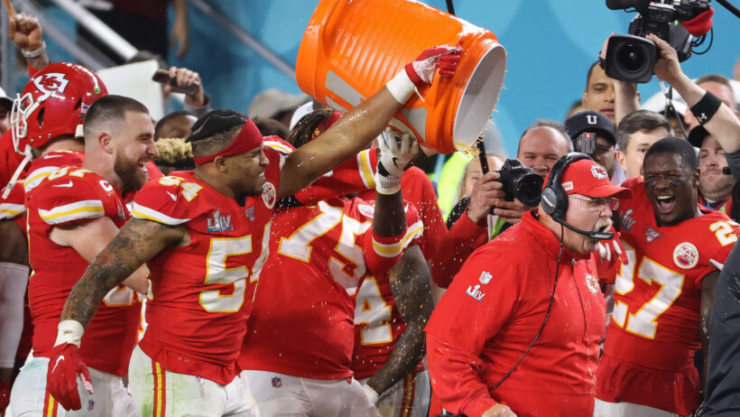 Kansas City Chiefs outside linebacker Damien Wilson (54), Chiefs tight end Travis Kelce (87), and Chiefs offensive tackle Cameron Erving (75) celebrate by dumping Gatorade on Chiefs head coach Andy Reid