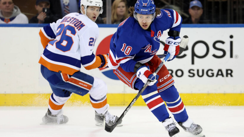 New York Rangers left wing Artemi Panarin controls the puck against New York Islanders right wing Oliver Wahlstrom