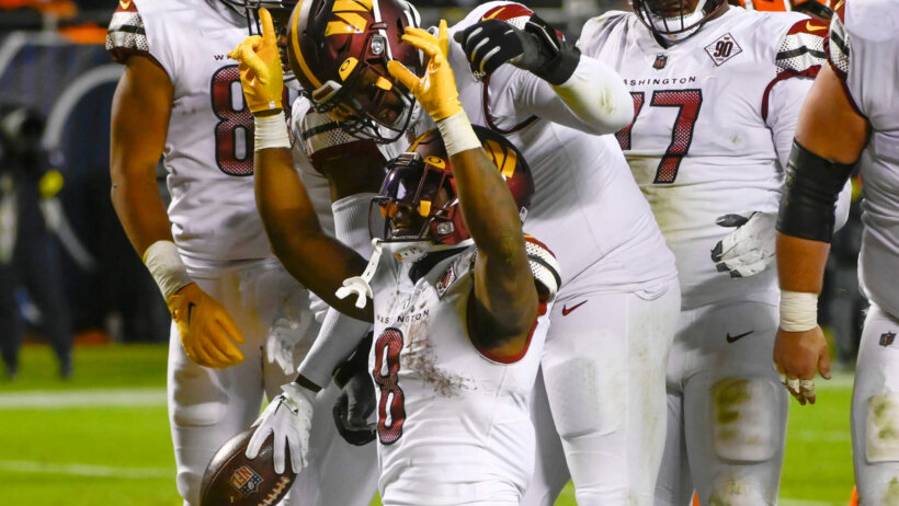 Commanders RB Brian Robinson celebrates a TD against the Chicago Bears.